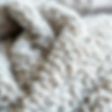 Close-up of the soft texture of a grey fuzzy blanket